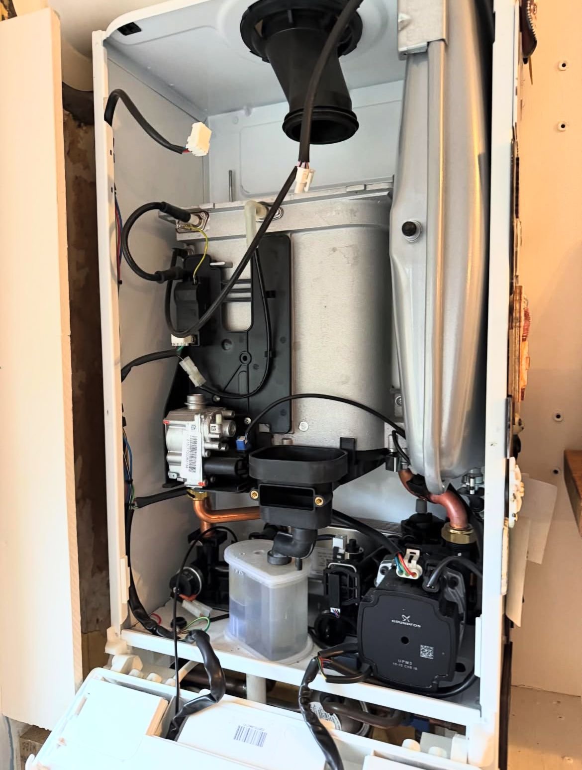 Open combi boiler being serviced by a MAMOSS Gas Safe heating engineer in East London