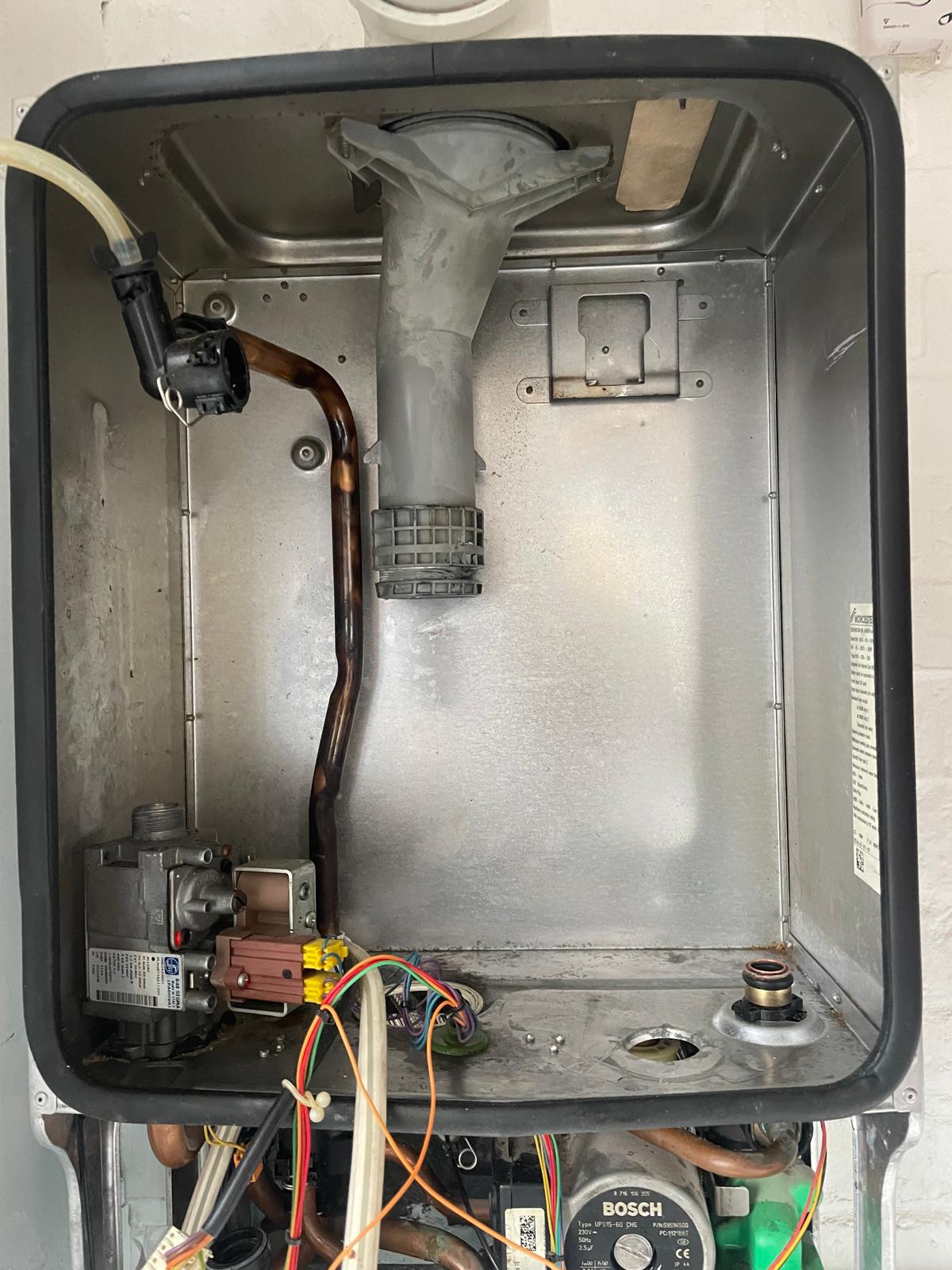 Boiler fully stripped showing flue connection, gas valve and burner components