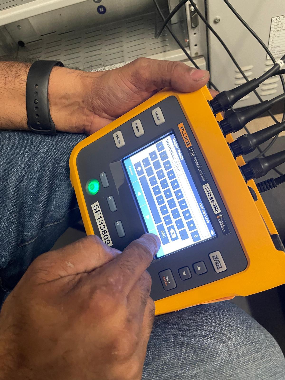 Fluke 1736 power logger being configured for electrical load monitoring